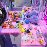 Multiple  Lama keychain with bell on pink table